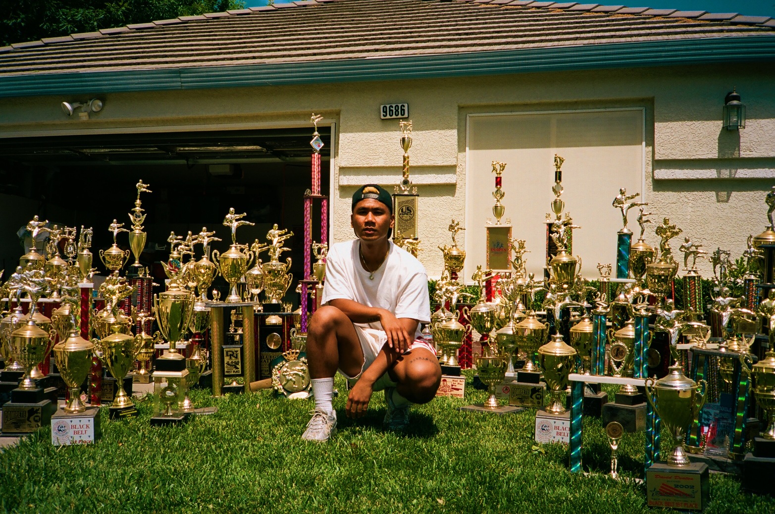 Rudy Reynon II surrounded by championship trophies